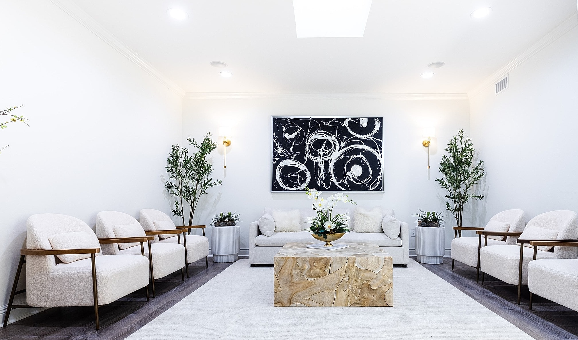 Modern living room with stylish decor and plants.