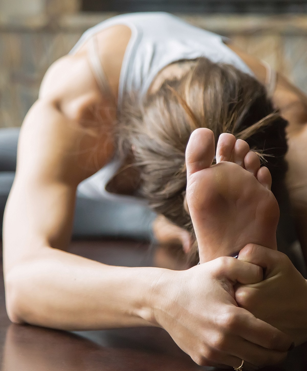 Person stretching and holding their foot.