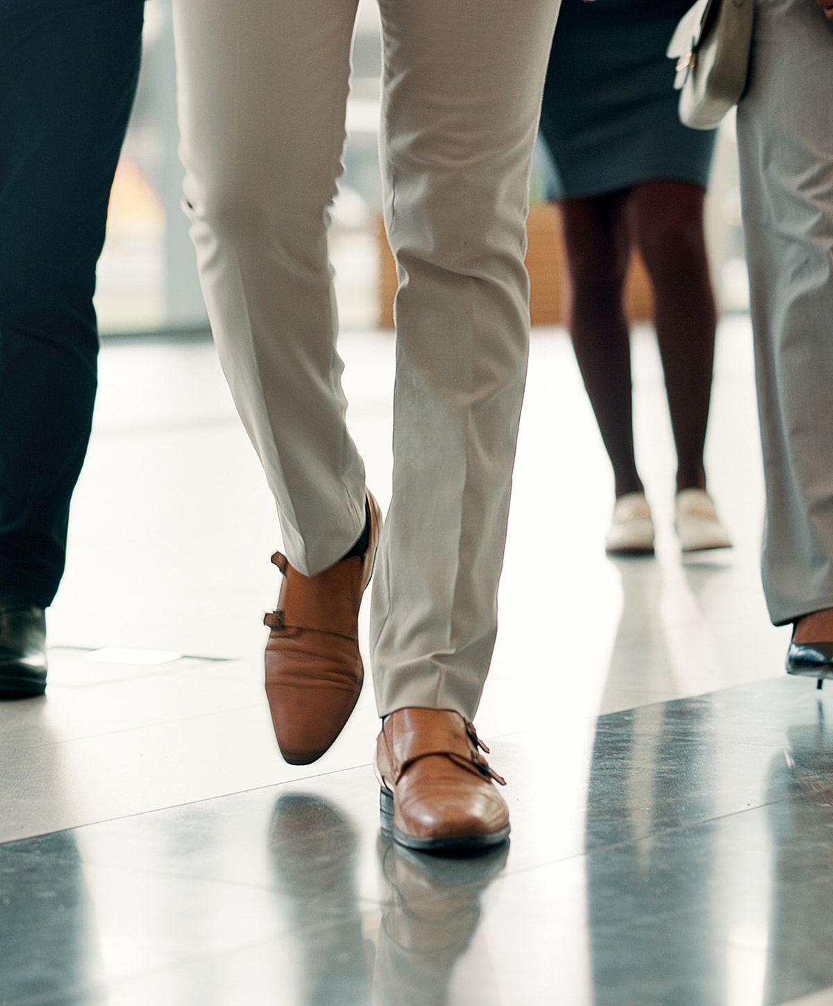 Business people walking in professional attire.