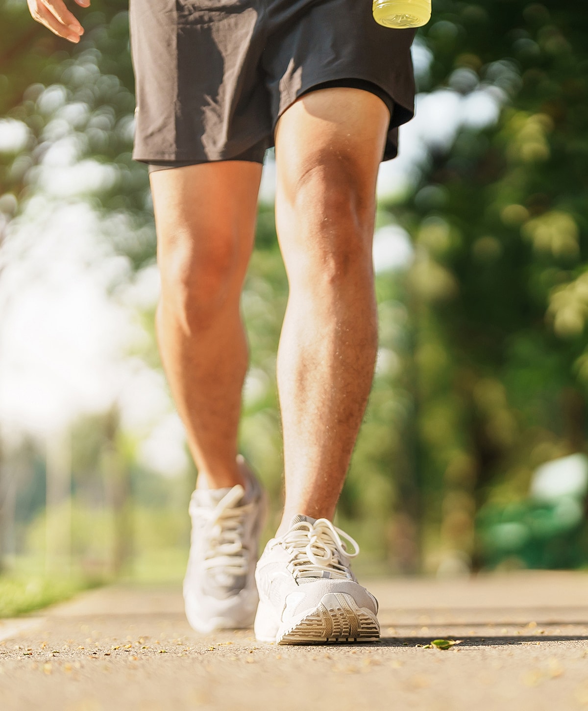 Person jogging on a sunny path.