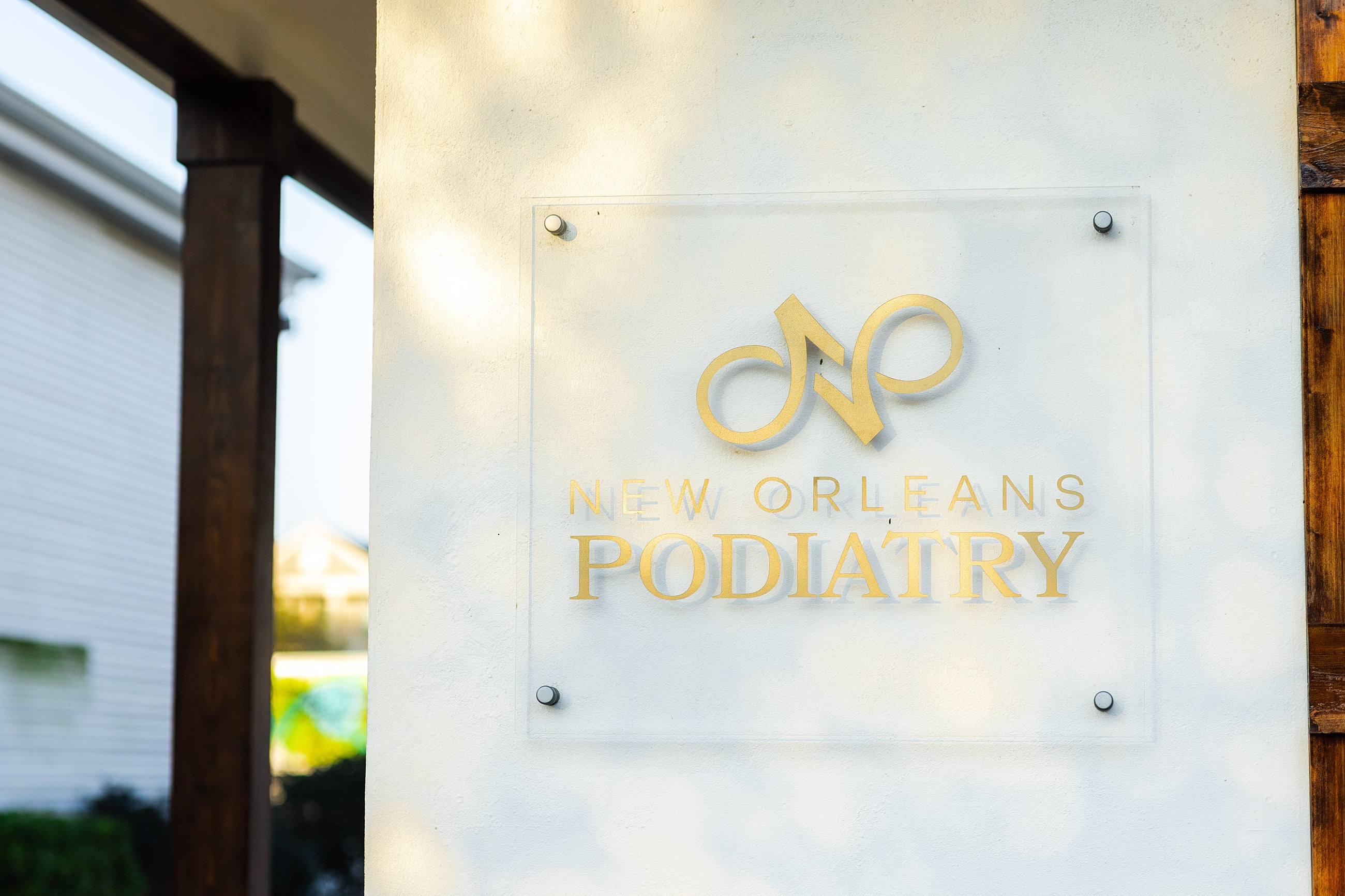 Woman adjusting black high heels outdoors.