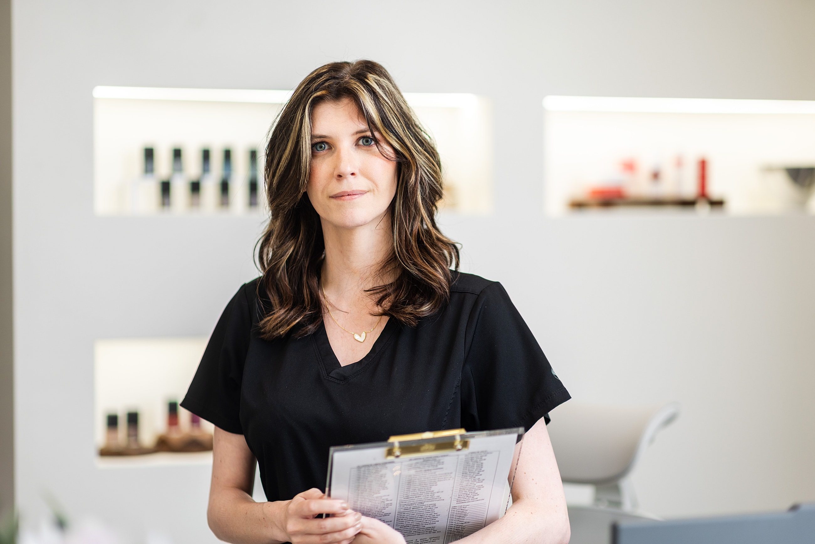 Woman holding a clipboard in a modern salon.