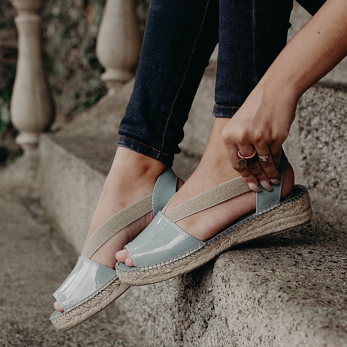 Espadrille sandals on a woman's feet outdoors.