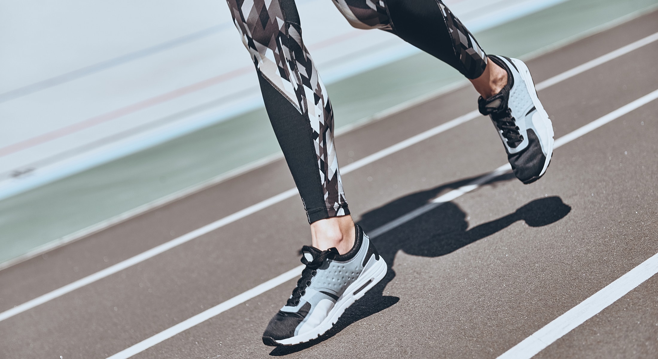 High heels on stylish feet in urban setting.