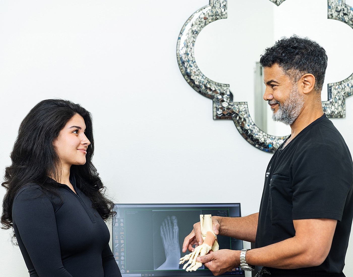 Person holding ankle, showcasing foot health.