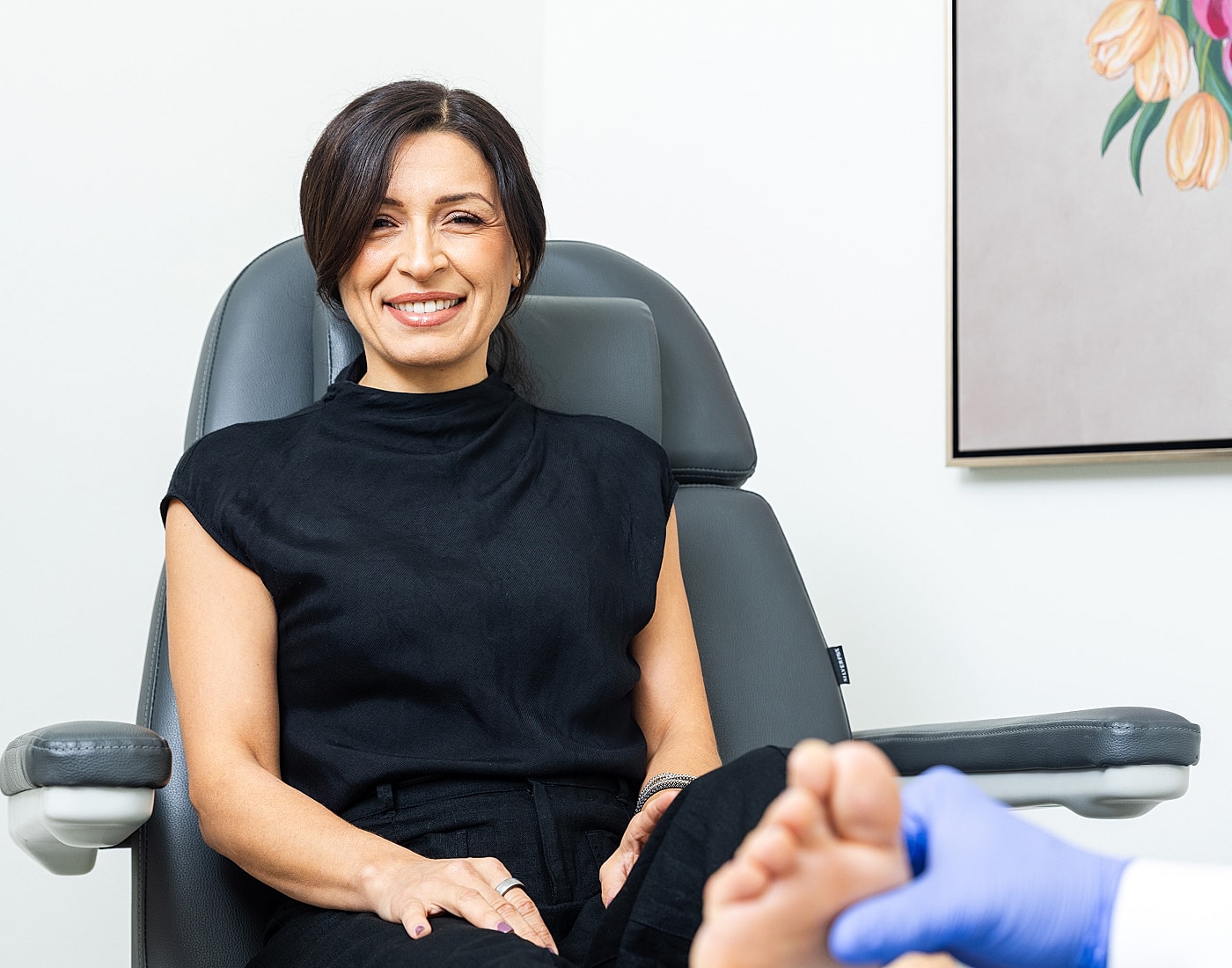 Black high-heeled sandals with bow detail.