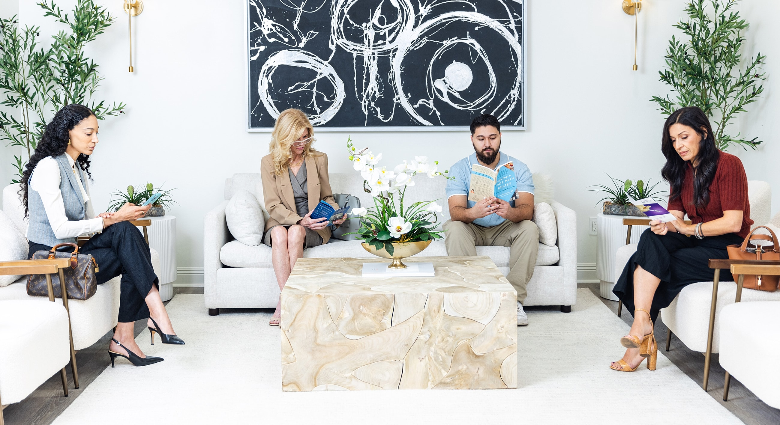 Group of people reading in modern waiting area.