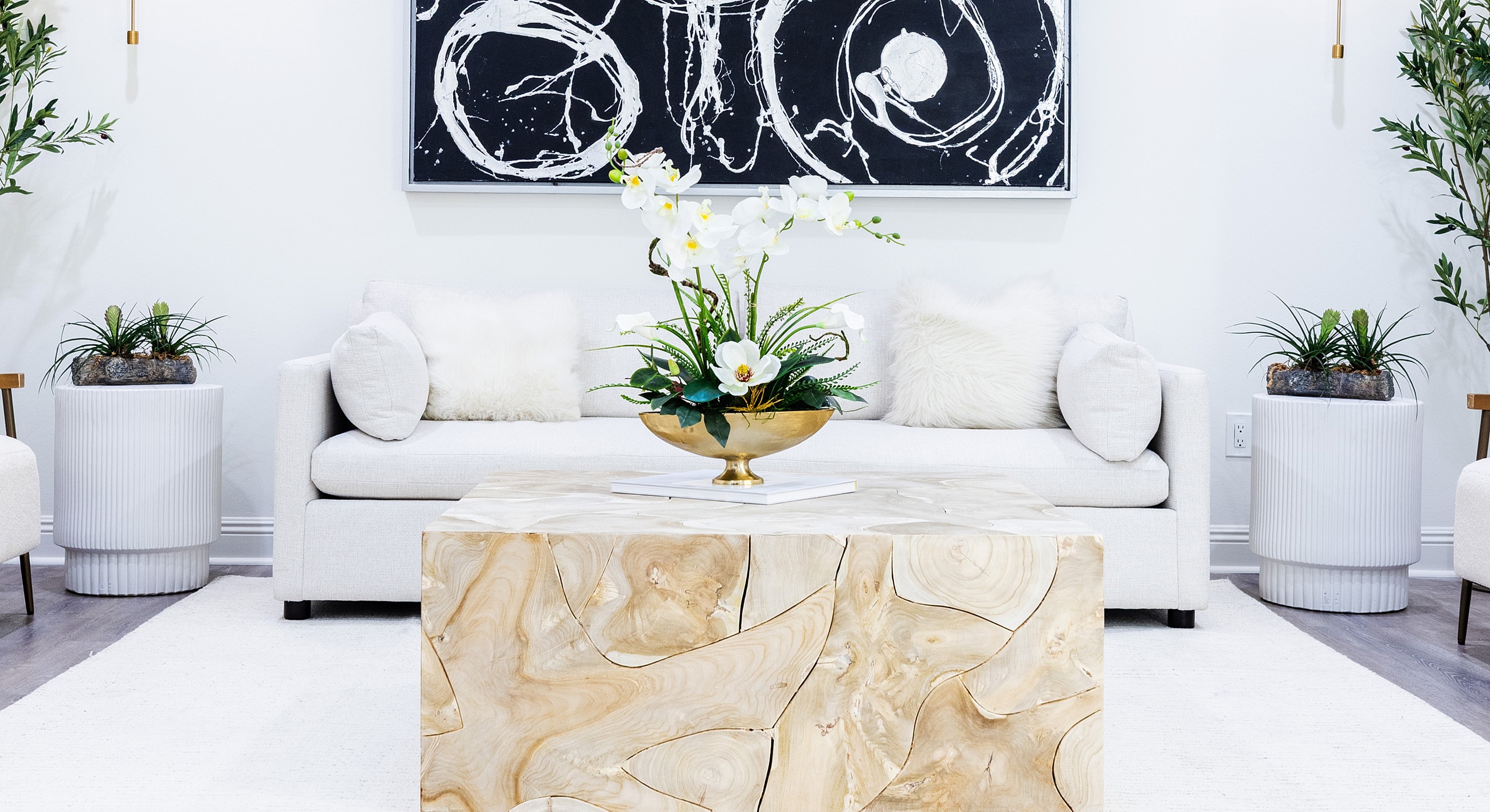 Modern living room with floral centerpiece and decor.