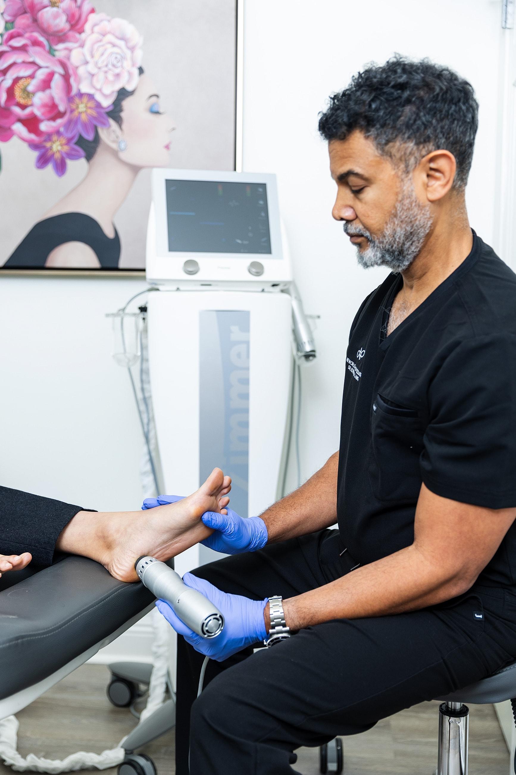 Podiatrist performing treatment on a patient's foot.