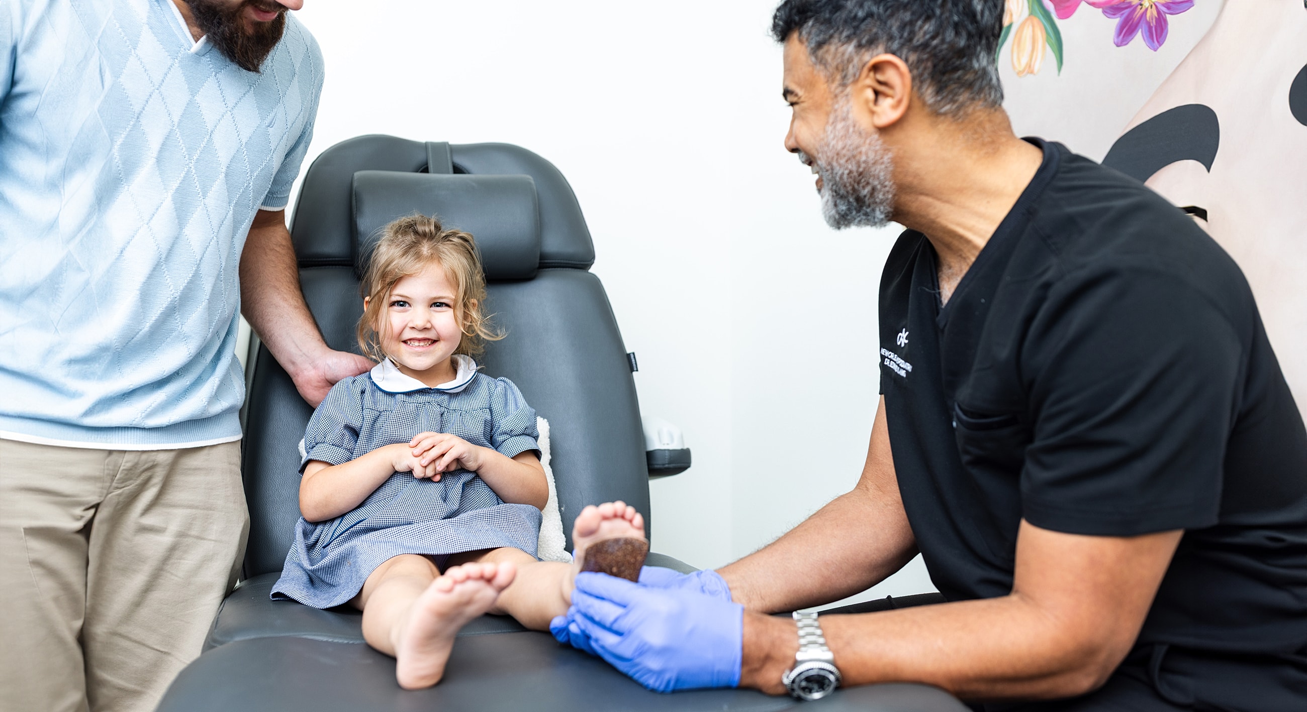 Child smiling during a medical checkup appointment.