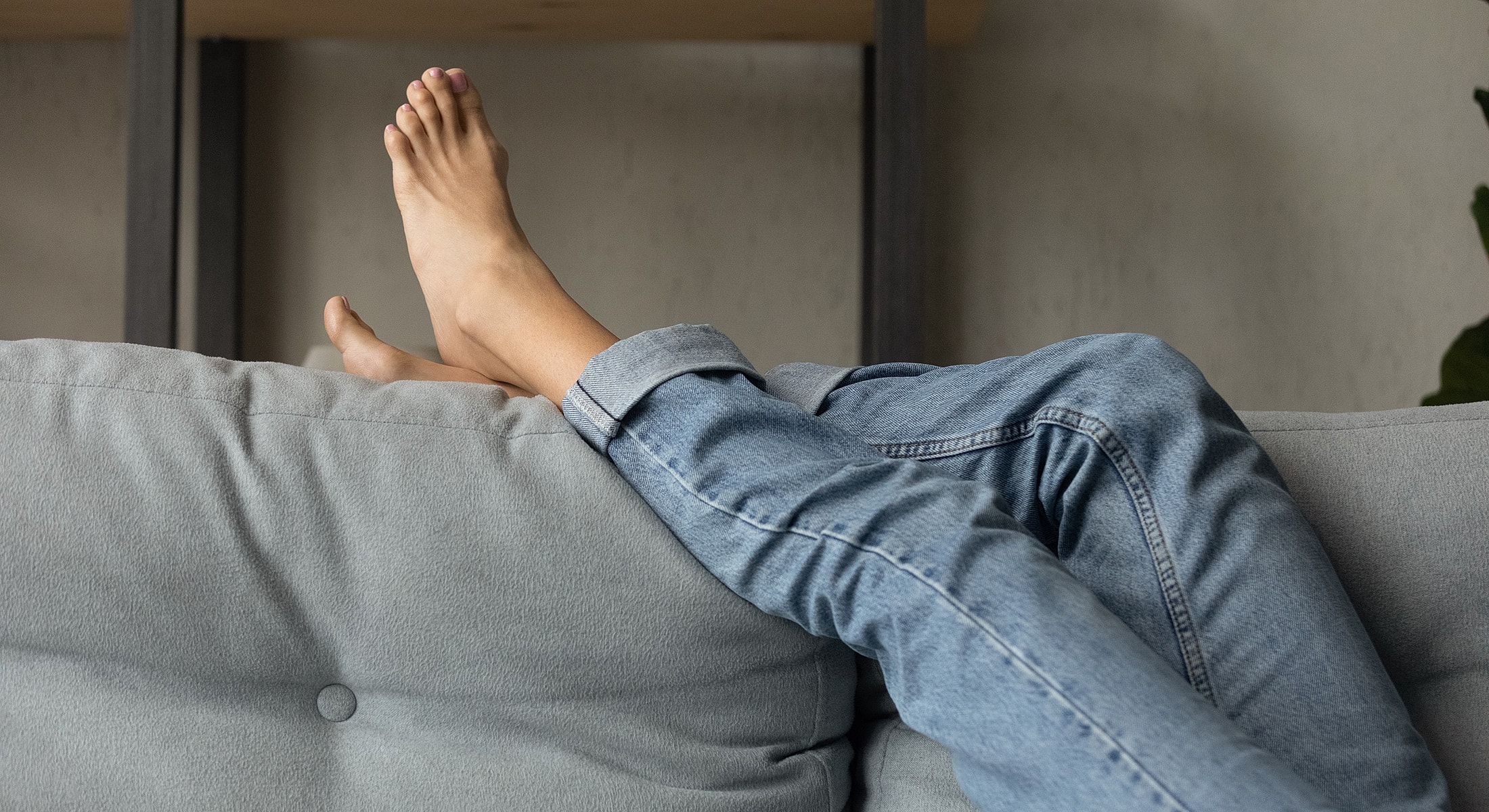 Barefoot person walking on wooden floor.