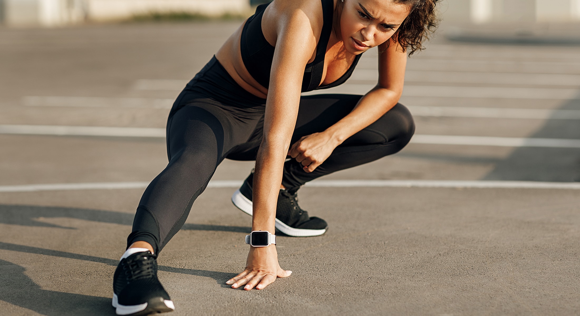 Woman stretching during outdoor workout session.